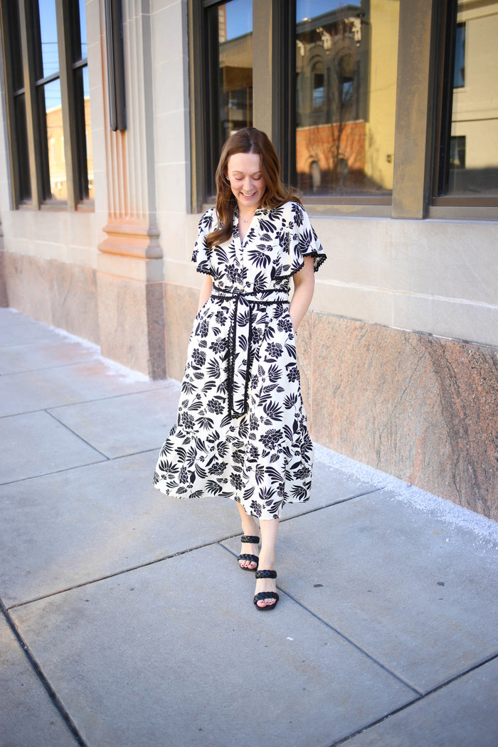 White and black floral print midi dress with scalloped hem details