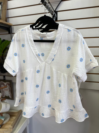 White top with blue and yellow embroidered daisies