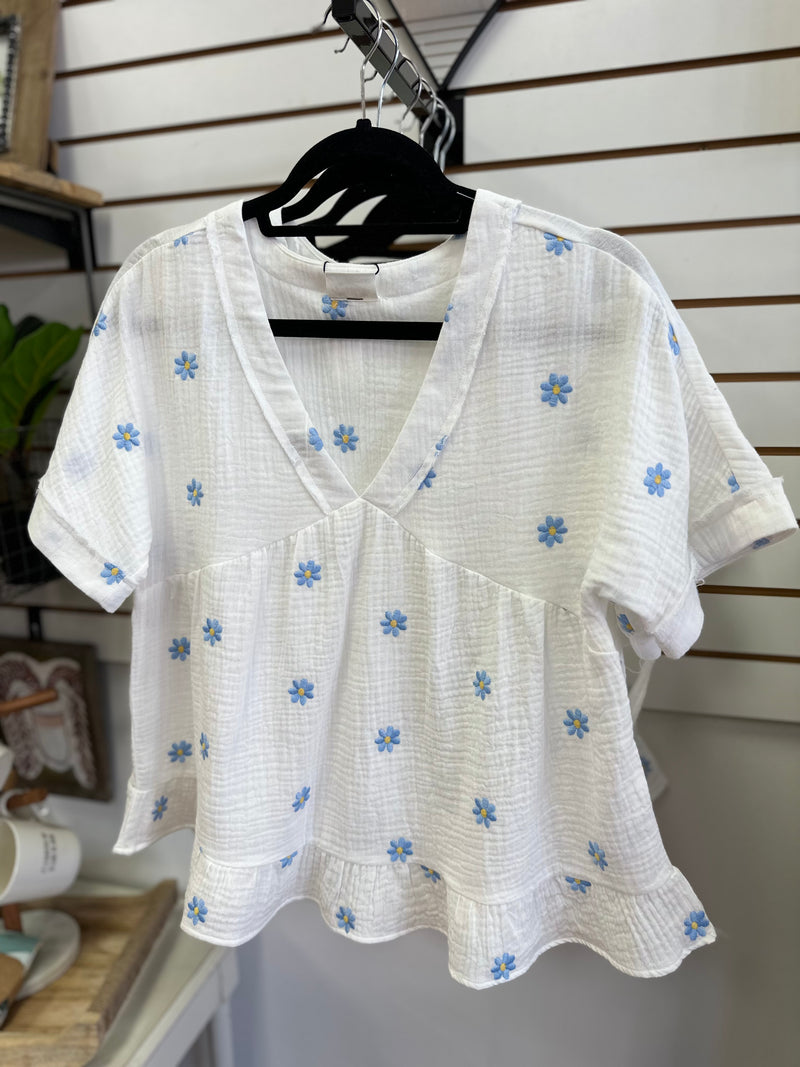 White top with blue and yellow embroidered daisies