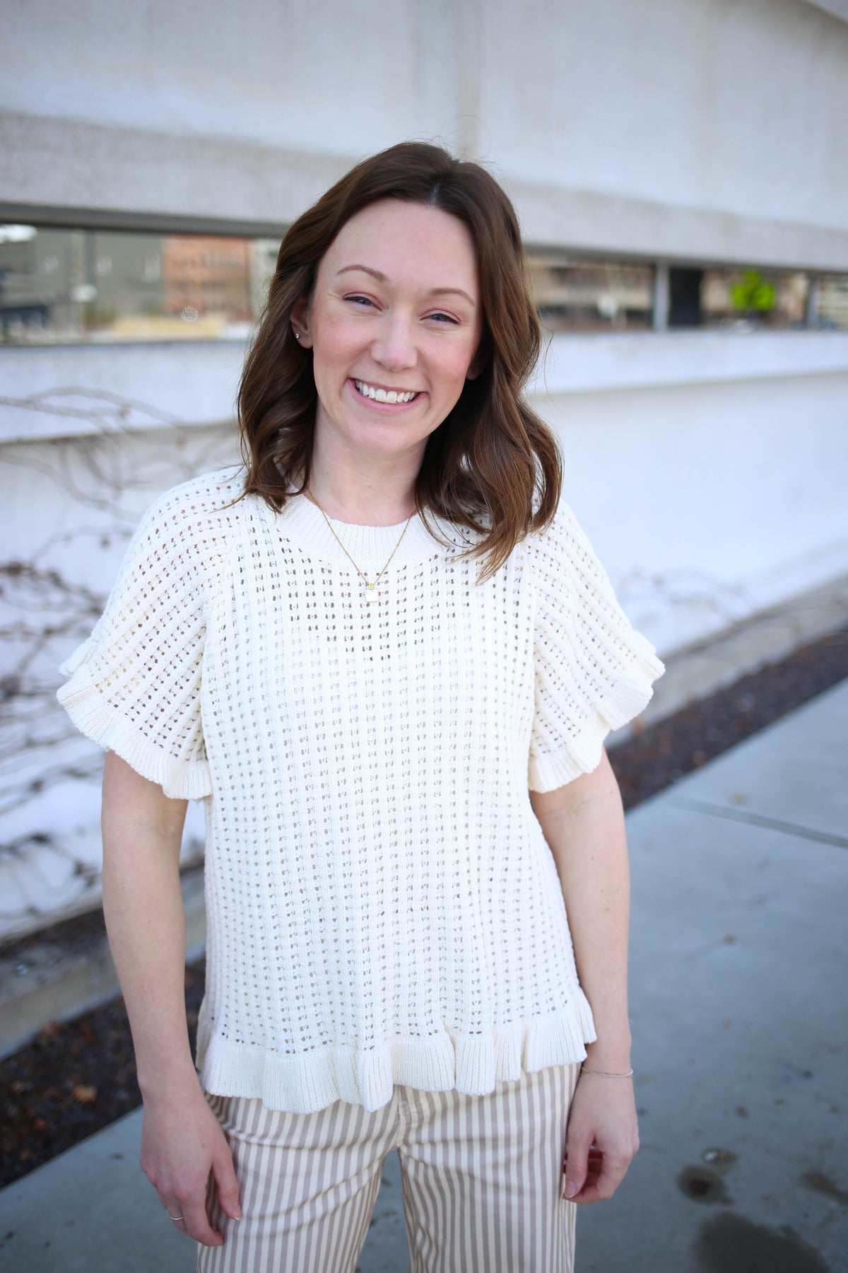 Ecru open knit and ruffle hem short sleeve top