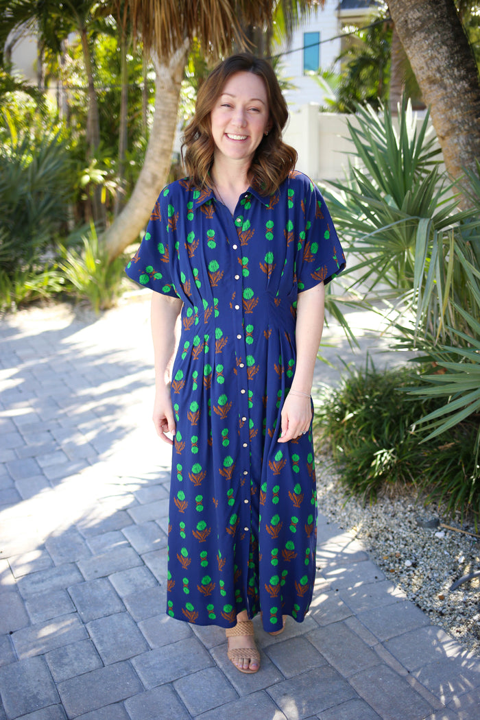 Navy and green printed midi dress with gold button down front and pleat detail waist