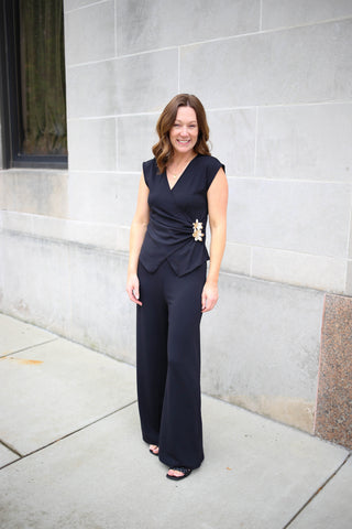 Black top and pants set with side gathered top and gold flower accent