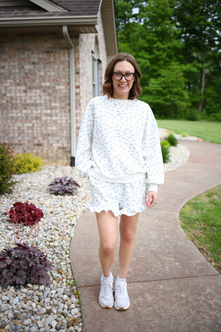 ivory top and shorts set with blue flowers bows and ruffle details