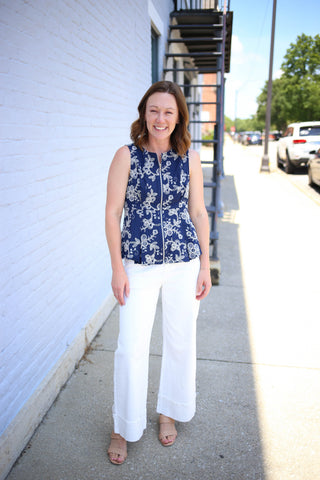 Navy sleeveless peplum top with off-white embroidery flowers detail