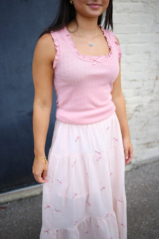 blush pink sleeveless top with bow and ruffle details