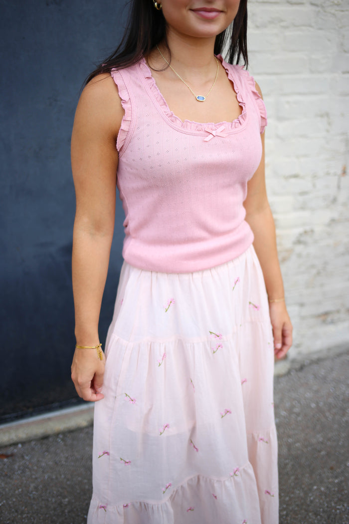 blush pink sleeveless top with bow and ruffle details