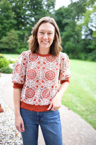Rust short sleeve top with cream crochet details